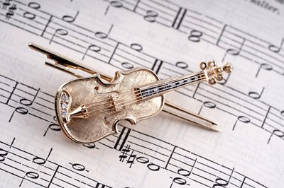 Lot 481 - A diamond and sapphire violin pattern brooch