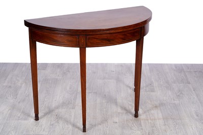 Lot 3 - A Georgian mahogany demilune fold over tea table