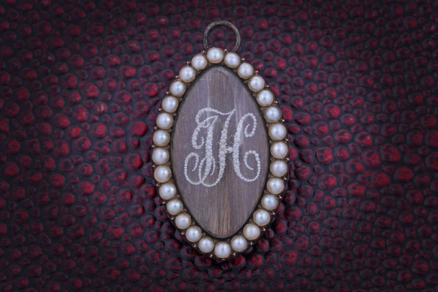 Lot 13 - A Georgian seed pearl mourning brooch
