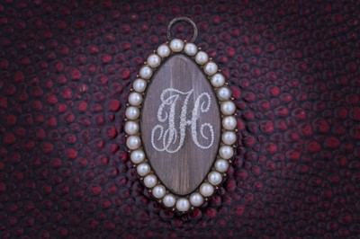 Lot 381 - A Georgian seed pearl mourning brooch