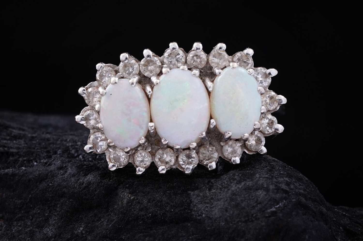 Lot 14 - An opal and diamond cluster ring