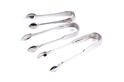 Lot 574 - Three pairs of silver sugar tongs