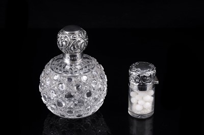 Lot 556 - A Victorian silver-mounted grenade form perfume bottle; and a smelling salts vial