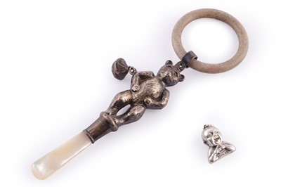 Lot 548 - A 1930s Cow and Gate sterling-silver baby advertising charm; and a silver Teddy bear rattle