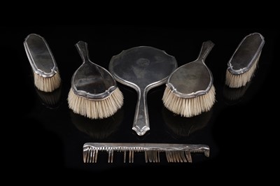 Lot 550 - A 1920s silver dressing table mirror and brush set