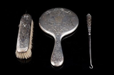 Lot 552 - An Edwardian silver mirror and brush set