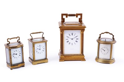 Lot 147 - An early 20th Century brass 8-day carriage clock; and three others