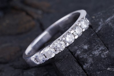 Lot 442 - A contemporary half-hoop eternity ring