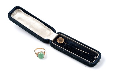 Lot 76 - A Chinese jade cabochon ring, and a tie pin