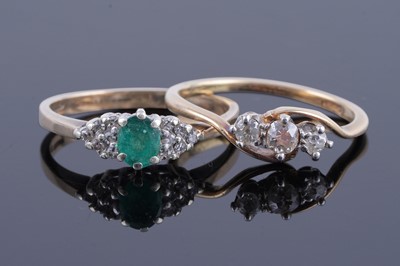 Lot 369 - An early 20th Century three-stone diamond ring; and an emerald and diamond ring