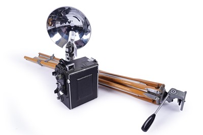 Lot 537 - A Folmer Graflex Speed Graphic rangefinder bellows camera; and a Graflex 2 cell flash