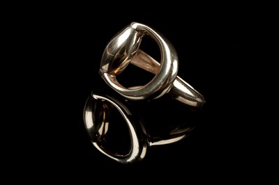 Lot 102 - A contemporary 9ct gold stirrup pattern ring