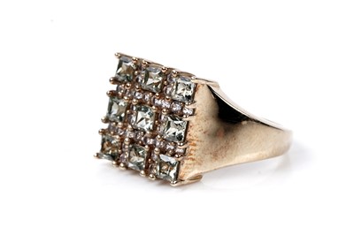Lot 108 - A green sapphire and white spinel ring