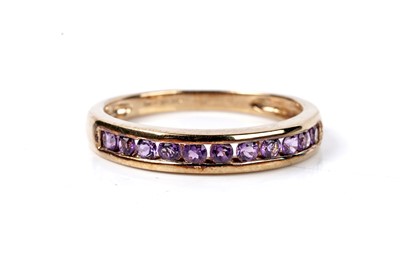 Lot 116 - A contemporary amethyst half-hoop eternity ring