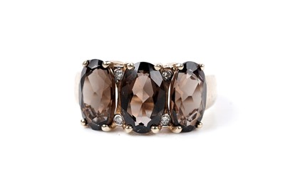 Lot 121 - A smoky quartz and diamond three-stone ring