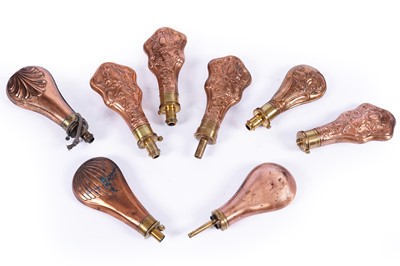 Lot 350 - A collection of eight copper and brass embossed powder flasks