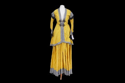 Lot 401 - A yellow jacket and dress with black and white striped trim designed by Richard Hudson