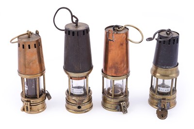 Lot 358 - A collection of four miner’s lamps