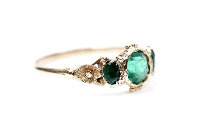 Lot 62 - A Victorian green paste three stone ring
