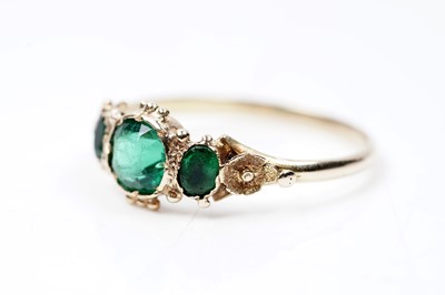 Lot 62 - A Victorian green paste three stone ring