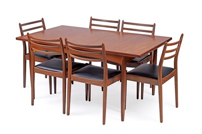 Lot 25 - Ib Kofod-Larsen for G Plan Danish: a teak extending dining table and chairs