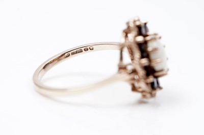 Lot 94 - A 1970s opal and garnet flower pattern dress ring