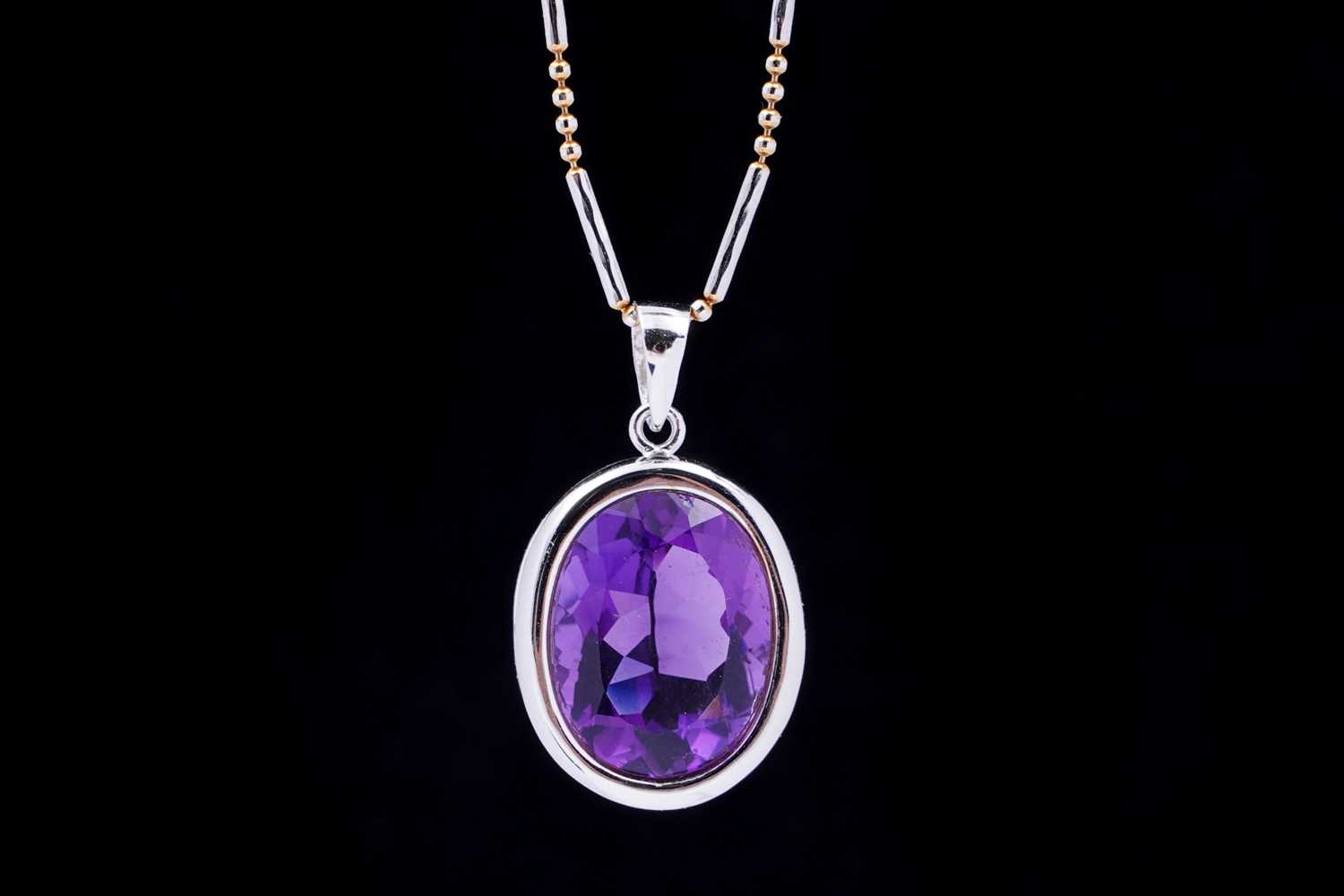 Lot 101 - A contemporary amethyst pendant on chain