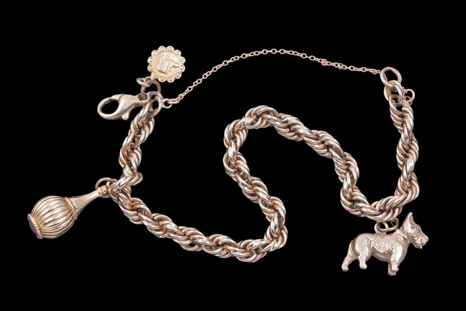 Lot 32 - A gold rope-twist charm bracelet