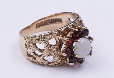 Lot 40 - A 1970s opal and garnet bark effect dress ring