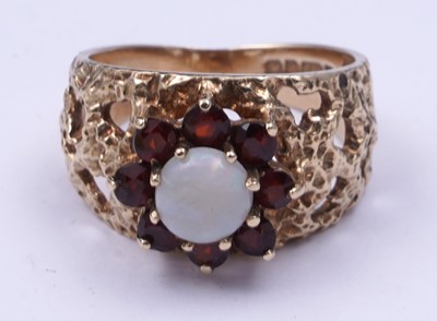 Lot 40 - A 1970s opal and garnet bark effect dress ring