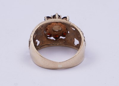 Lot 40 - A 1970s opal and garnet bark effect dress ring