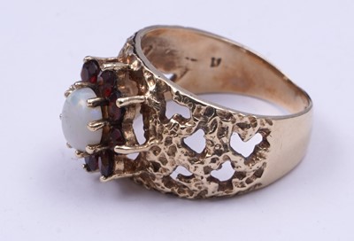 Lot 40 - A 1970s opal and garnet bark effect dress ring