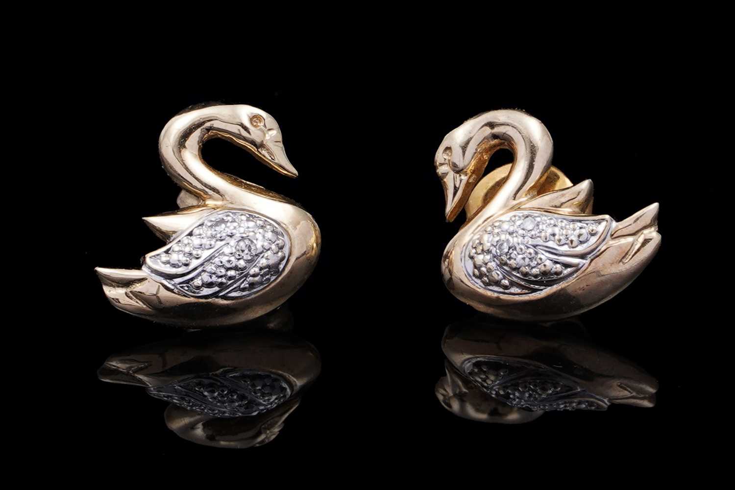 Lot 41 - A pair of swan pattern earrings set with diamonds