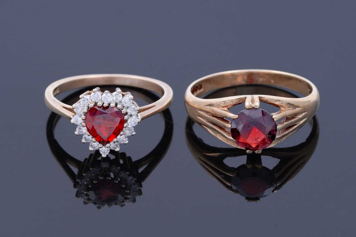Lot 42 - A red tourmaline love heart ring; and a garnet ring