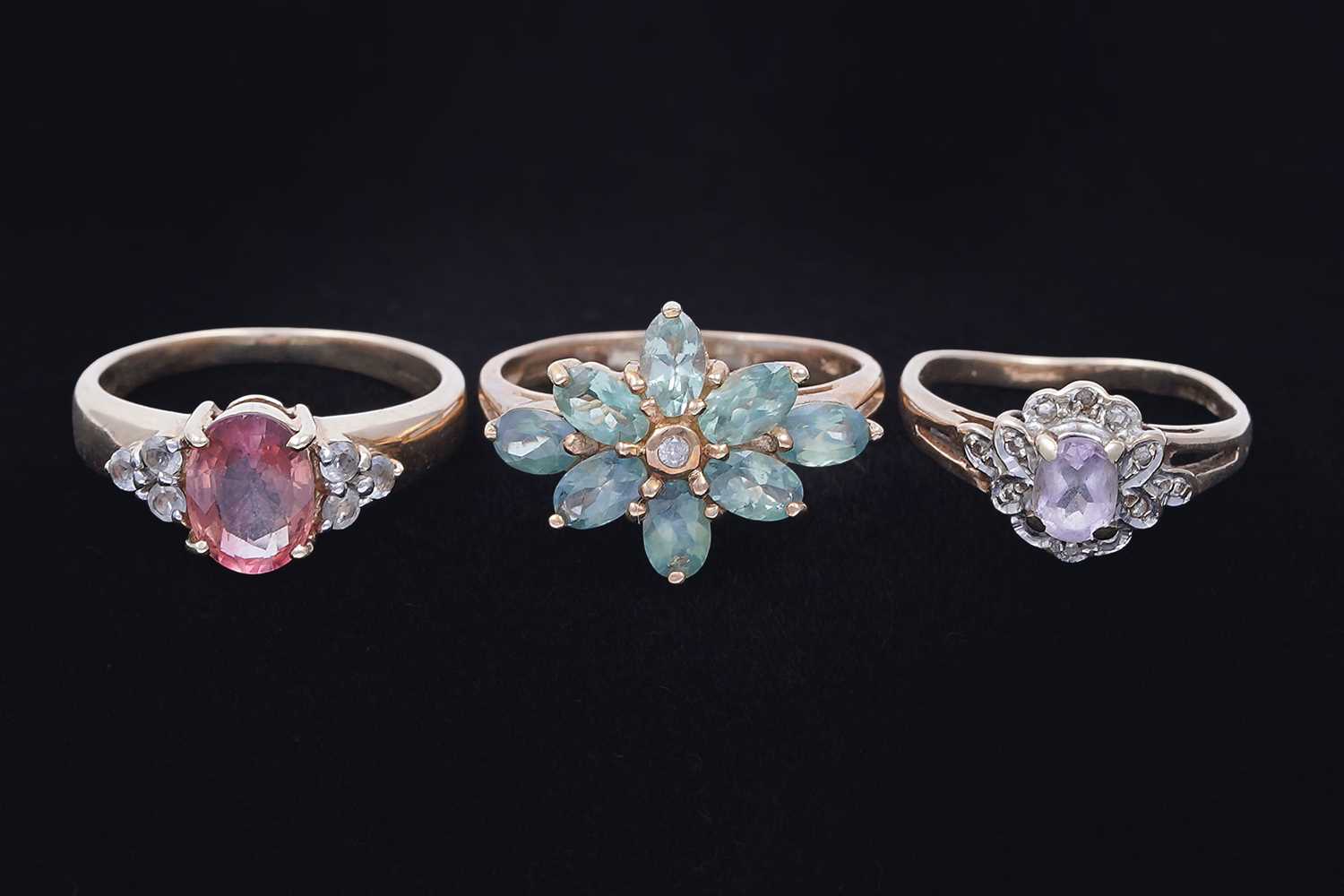 Lot 45 - Three gemstone rings, including a morganite and goshenite three stone ring