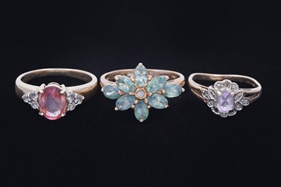 Lot 45 - Three gemstone rings, including a morganite and goshenite three stone ring