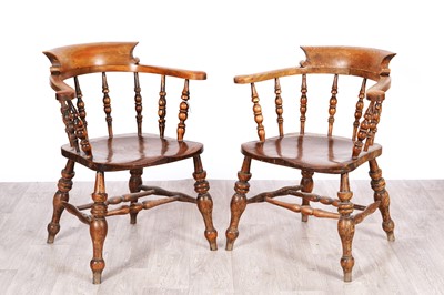 Lot 93 - A near pair of late 19th/early 20th Century beech and elm smoker’s armchairs