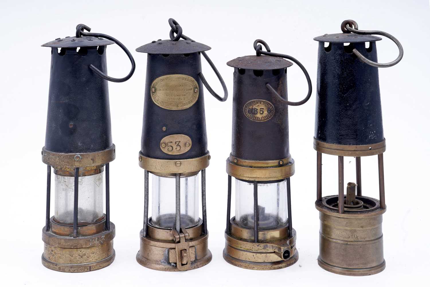 Lot 197 - A collection of four ‘Protector’ type lamps