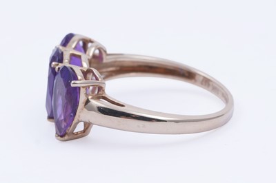 Lot 26 - A contemporary three-stone amethyst ring