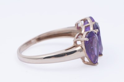 Lot 26 - A contemporary three-stone amethyst ring