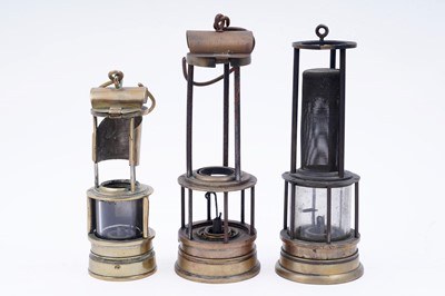 Lot 242 - A collection of three part ‘Clanny’ type lamps