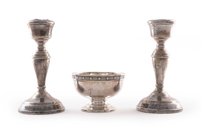 Lot 205 - A pair of Elizabeth II silver candlestick holders; and a Lindisfarne pattern bonbon dish