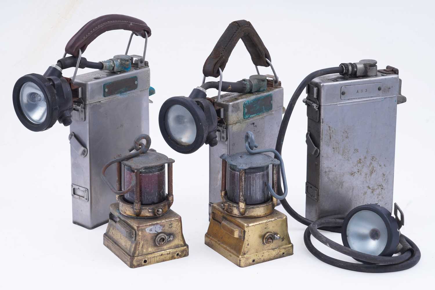 Lot 164 - Three mid-20th Century Alkaline inspection lamps; and two brass-cased signal lamps