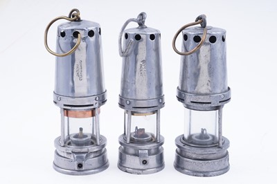 Lot 178 - Three aluminium-bodied ‘Guys Shield Patent’ lamps