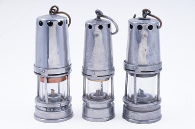 Lot 178 - Three aluminium-bodied ‘Guys Shield Patent’ lamps
