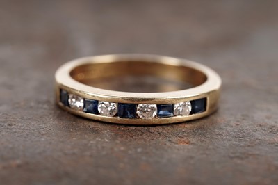 Lot 20 - A modern sapphire and diamond half hoop eternity ring