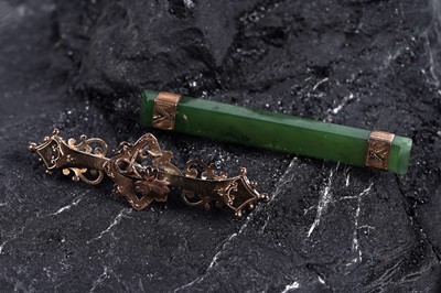 Lot 27 - A Victorian Gothic Revival 9ct rose gold bar brooch; and an Edwardian spinach jade bar brooch