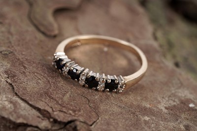 Lot 47 - A modern sapphire and diamond half hoop eternity ring