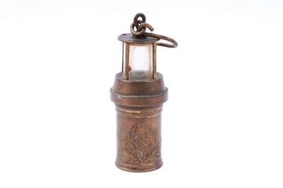 Lot 245 - Four figural studies of miners; and a selection of miniature or presentation miner’s lamps