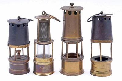 Lot 245 - Four figural studies of miners; and a selection of miniature or presentation miner’s lamps